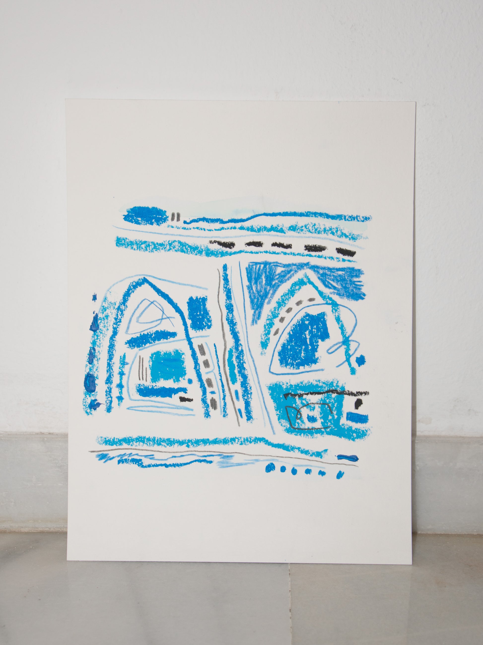 Abstract blue drawing on a white sheet of paper against a light gray background